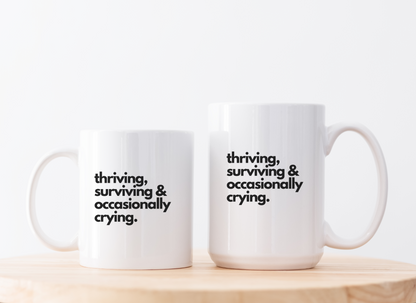 Funny Coffee Mug – “Thriving, Surviving, and Occasionally Crying” | Ceramic Mug for Self-Care & Laughs